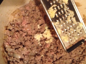 Add in the garlic. I grate mine. Much easier than mincing by hand.
